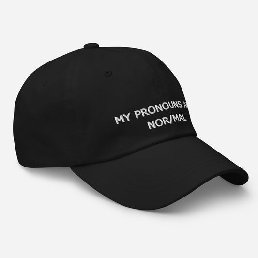 a black baseball cap with MY PRONOUNS ARE NOR/MAL embroidered on it in white